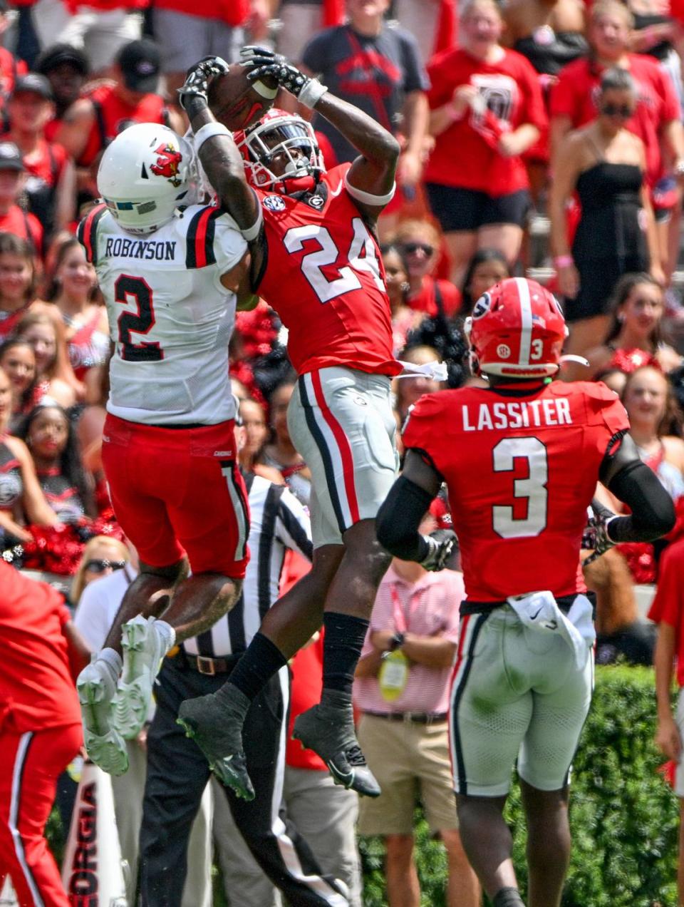 Georgia defensive back Malaki Starks (24) hauls in an interception during the Bulldogs’ victory over Ball State Saturday in Athens.