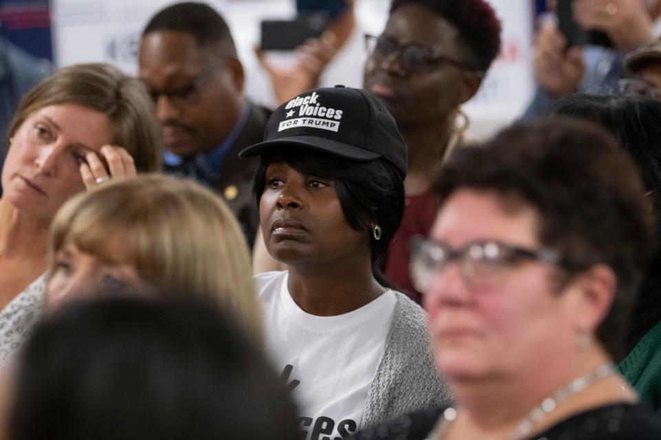 Alicia Healy of the East Side listens during a Black Voices for Trump rally in Westerville on Wednesday, Oct. 21, 2020. 