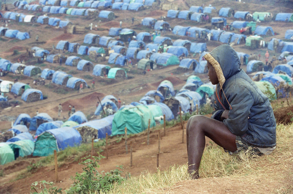 FILE - A young Tutsi refugee gazes upon the Tutsi camp of Nyarushishi, on August 25, 1994, 6 miles southeast of Cyangugu, Rwanda. A frail 87-year-old Rwandan, Félicien Kabuga, accused of encouraging and bankrolling the 1994 genocide in his home country goes on trial Thursday, Sept. 29, 2022, at a United Nations tribunal, nearly three decades after the 100-day massacre that left 800,000 dead. (AP Photo/Jean-March Bouju, File)