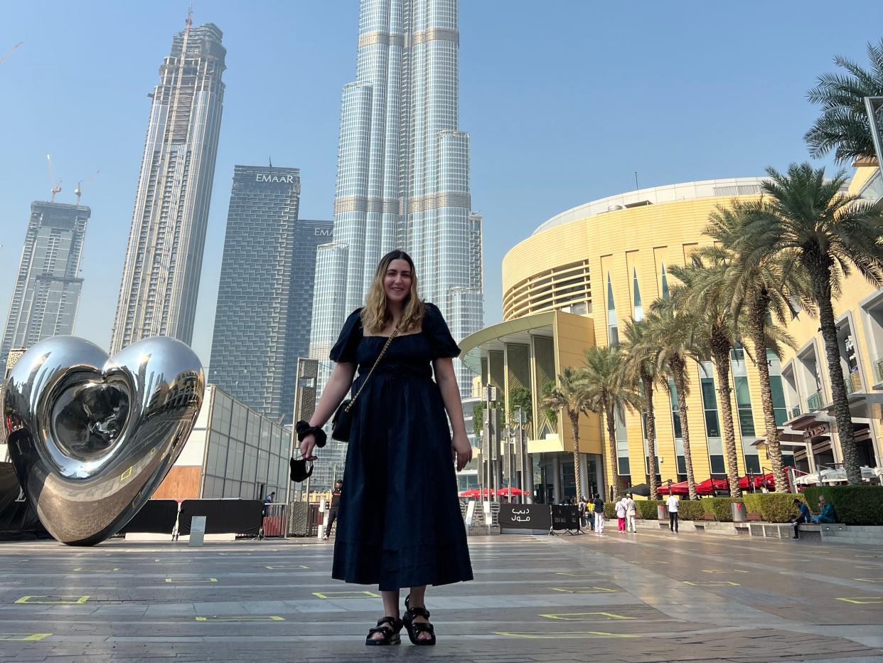 The writer stands in front of skyscraper in Dubai