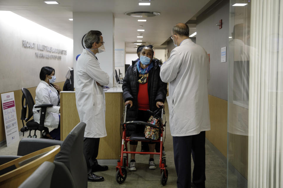 Trachea transplant recipient Sonia Sein talks with the lead surgeon of her procedure, Dr. Eric Genden, left, and Dr. Sandy Florman during a checkup visit at Mt. Sinai hospital in New York on Monday, March, 22, 2021. Doctors say this operation could help other people including COVID-19 patients left with serious windpipe damage from breathing machines. (AP Photo/Marshall Ritzel)