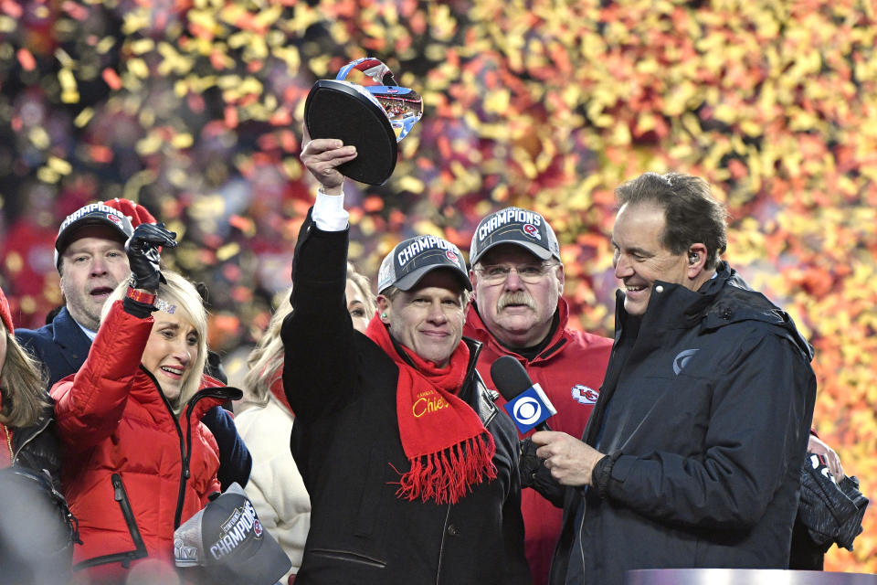 FILE - Norma Hunt, left, and her son Clark Hunt, center, owners of the Kansas City Chiefs, and Chiefs head coach Andy Reid, second right, celebrate after the AFC Championship NFL football game against the Tennessee Titans in Kansas City, Mo., Jan. 19, 2020. For the first time since her husband Lamar Hunt coined the term “Super Bowl,” and their team promptly lost to the Green Bay Packers, the matriarch of the Kansas City Chiefs will not be at the big game Sunday. Norma Hunt died this past summer at the age of 85, leaving a void that is still being felt among the Chiefs, and in particular, her son and team chairman Clark Hunt. (AP Photo/Jeff Roberson, File)