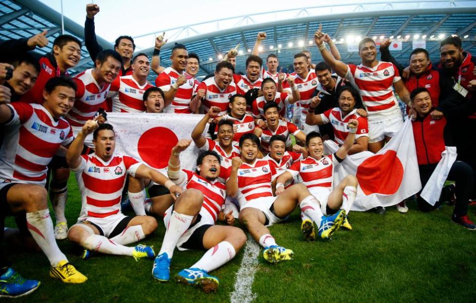 Japan celebrate after their stunning victory against South Africa at the 2015 Rugby World Cup