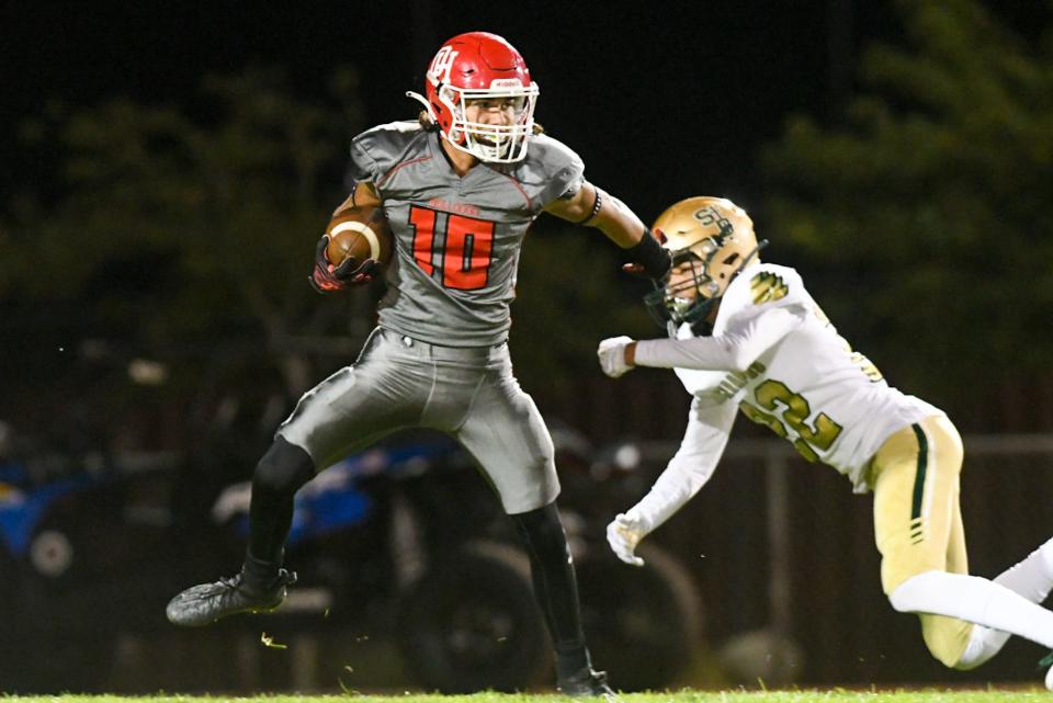 Oak Hills' Shane Young eludes a St. Bonaventure defender before returning a punt for a touchdown Thursday, Sept. 15, 2022. The Bulldogs won 35-21.