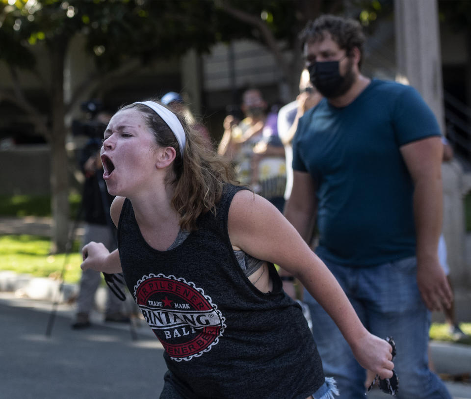 Counterprotesters yell from across the street at supporters of Republican Reps. Marjorie Taylor Greene and Matt Gaetz at a rally outside City Hall on Saturday, July, 17, 2021, in Riverside, Calif. (Cindy Yamanaka/The Orange County Register via AP)