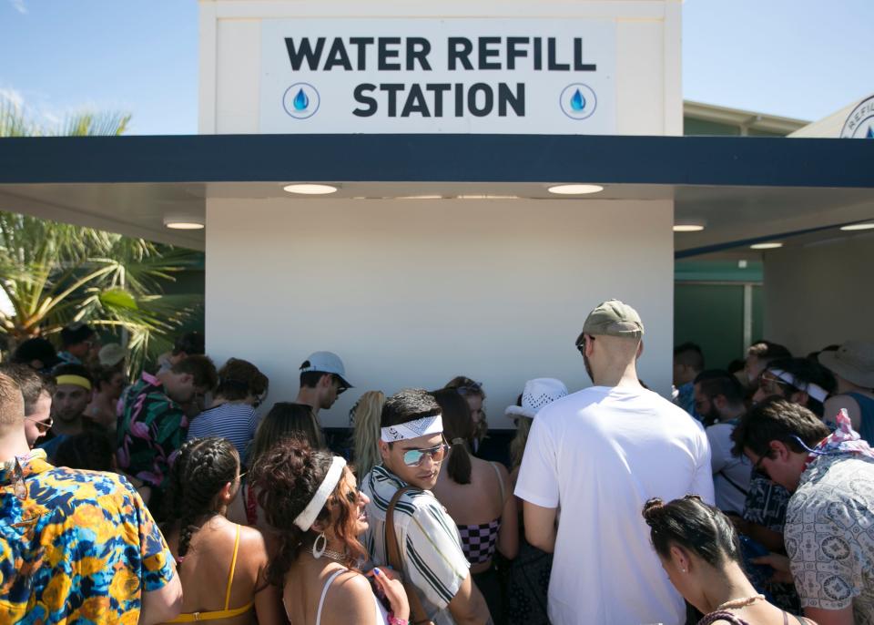 Festival goers gather in line at a water refill station at the Coachella Valley Music and Arts Festival in Indio, Calif. on April 19, 2019.