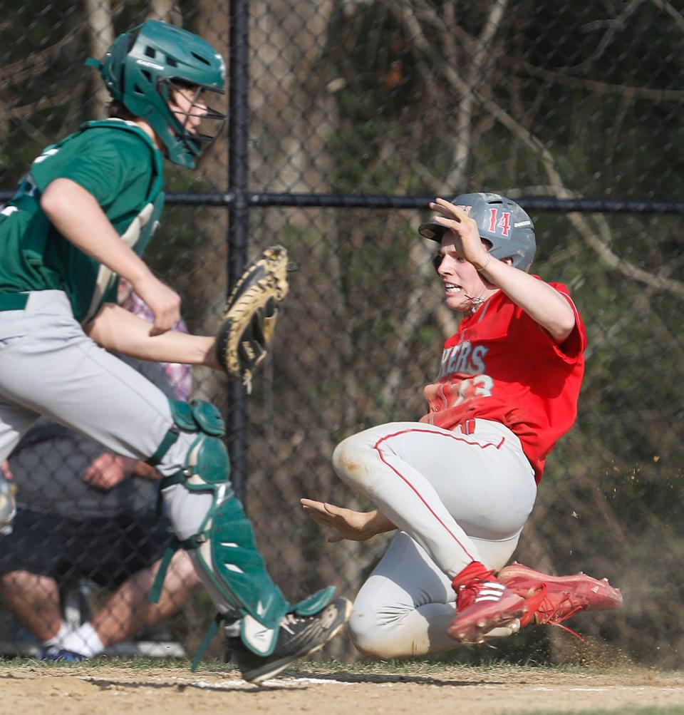 SL infielder Jack Quigley beats a tag by Duxbury catcher at the plate for the first SL score.Duxbury hosted Silver Lake High in baseball  on Friday April 14, 2023 