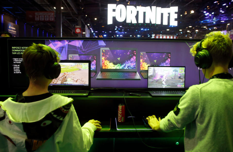 Gamers play the video game 'fortnite' developed by Epic Games on a laptop from the Razer company during the 'Paris Games Week' on October 25, 2018 in Paris, France. 'Paris Games Week' is an international trade fair for video games and runs from October 26 to 31, 2018.  (Photo by Chesnot/Getty Images)