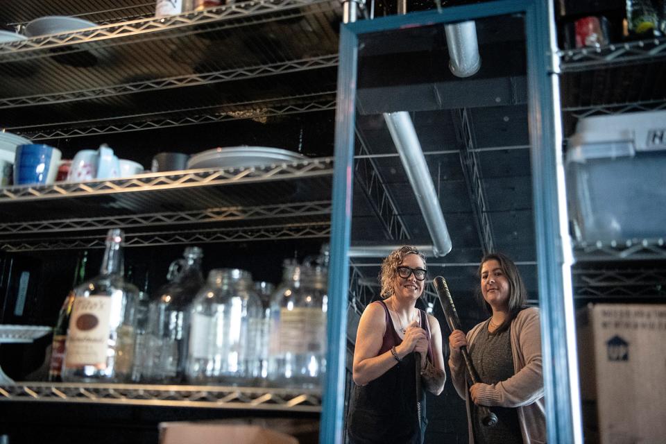 Kelly Bridges, left, and Kelly Lucy, co-owners of The Breakroom Rage Room are reflected in a mirror ready for smashing in Asheville June 8, 2023.