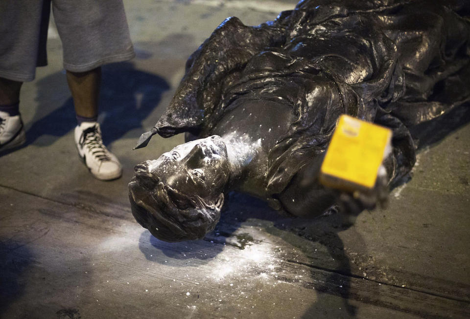 Wisconsin's "Forward" statue lies in the street on Capitol Square in Madison, Wis. Tuesday, June 23, 2020. Crowds outside the Wisconsin State Capitol tore down two statues and attacked a state senator amid protests following the arrest of a Black man who shouted at restaurant customers through a megaphone while carrying a baseball bat. (Emily Hamer/Wisconsin State Journal via AP)