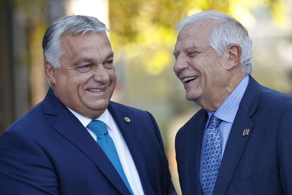 Hungary's Prime Minister Viktor Orban, left and European Union foreign policy chief Josep Borrell greet each other on arrival for the 2nd day of the Europe Summit in Granada, Spain, Friday, Oct. 6, 2023. European Union leaders have pledged Ukrainian President Volodymyr Zelenskyy their unwavering support. On Friday, they will face one of their worst political headaches on a key commitment. How and when to welcome debt-laden and war-battered Ukraine into the bloc. (AP Photo/Fermin Rodriguez)