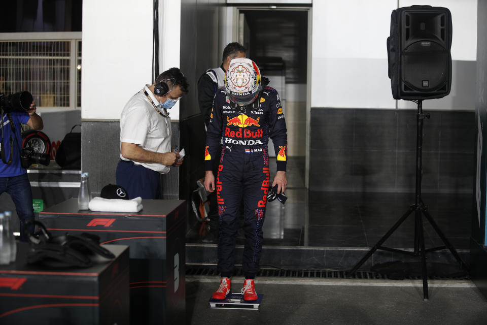 Red Bull driver Max Verstappen of the Netherlands stand on a scale after qualifying session qualifying session in Lusail, Qatar, Saturday, Nov. 20, 2021 ahead of the Qatar Formula One Grand Prix. (Hamad I Mohammed, Pool via AP)