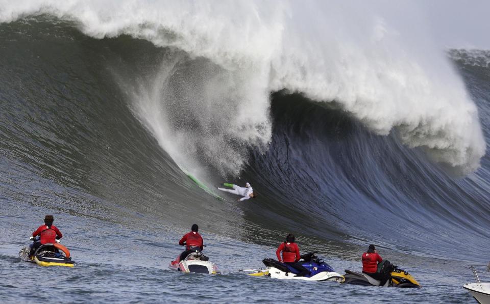 Nic Lamb goes tumbling into a wave during the third heat of the first round of the Mavericks Invitational big wave surf contest Friday, Jan. 24, 2014, in Half Moon Bay, Calif. (AP Photo/Eric Risberg)