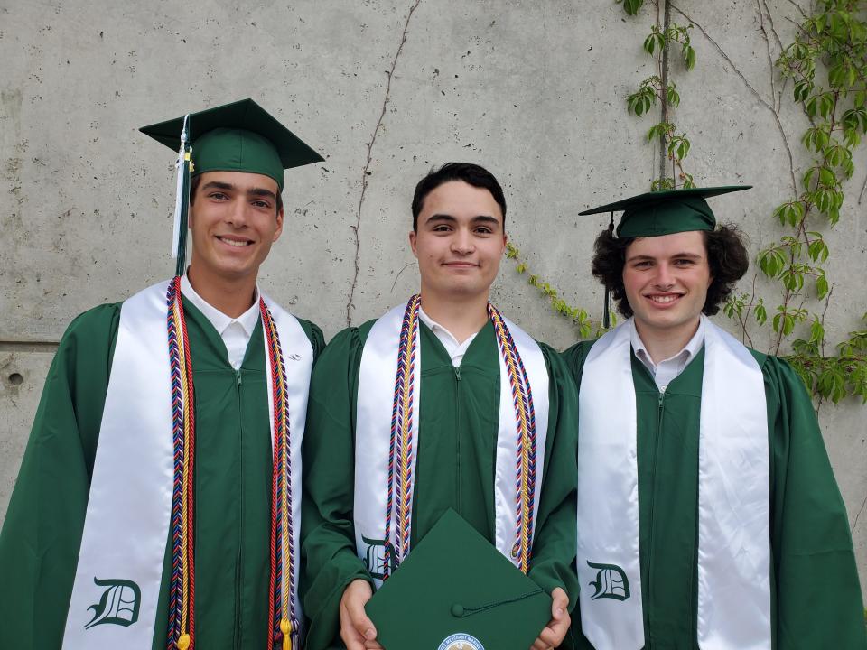 Dover High School graduates Ethan Proto, left, Isaac Davis, and Jake Gagnon, celebrate at the commencement Thursday, June 6, 2024 at the Whittemore Center in Durham.