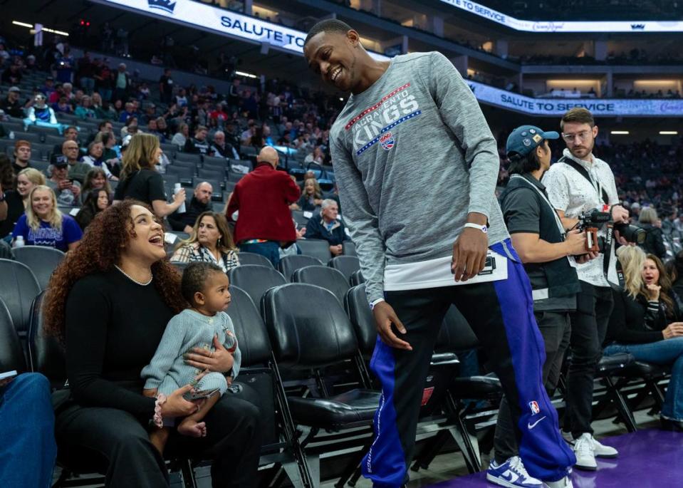Sacramento Kings guard De’Aaron Fox (5) laughs with his wife Recee and son Reign before a NBA basketball game at Golden 1 Center on Monday.