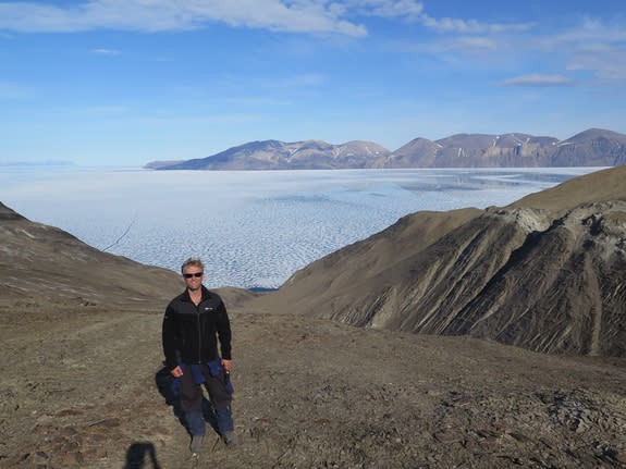 Paul Wignall in the field in Cape St. Andrew, one of the northernmost locations in the world. Behind him, Otto Fiord, a valley carved by glacial activity.