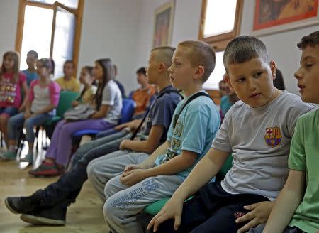 Members of children's choir "Superar" practise the songs that will be performed during the visit of the Pope to Sarajevo at their music school in Srebrenica, Bosnia and Herzegovina May 23, 2015. REUTERS/Dado Ruvic