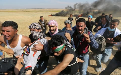 People react as they evacuate deaf Palestinian Tahreer Abu Sabala, 17, who was shot and wounded in the head during clashes with Israeli troops, at Israel-Gaza border - Credit: Reuters