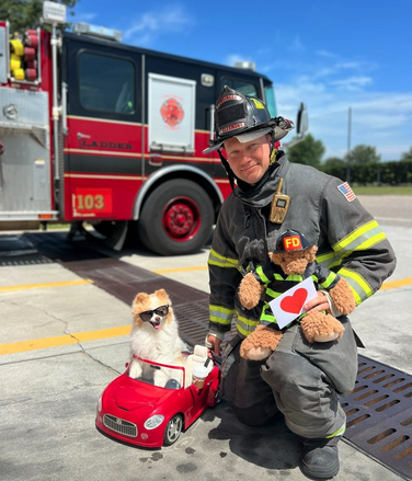 Koda the Fluff with a firefighter