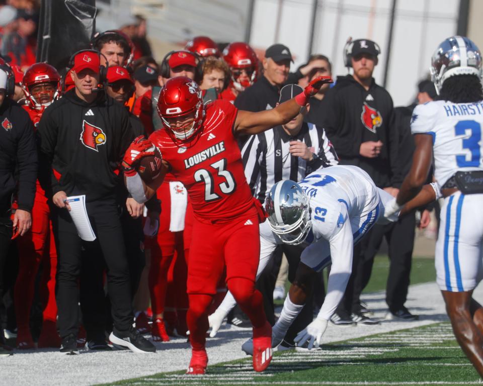 Louisville’s Isaac Guerendo gets a first down against Kentucky’s J.J. Weaver.
Nov. 25, 2023