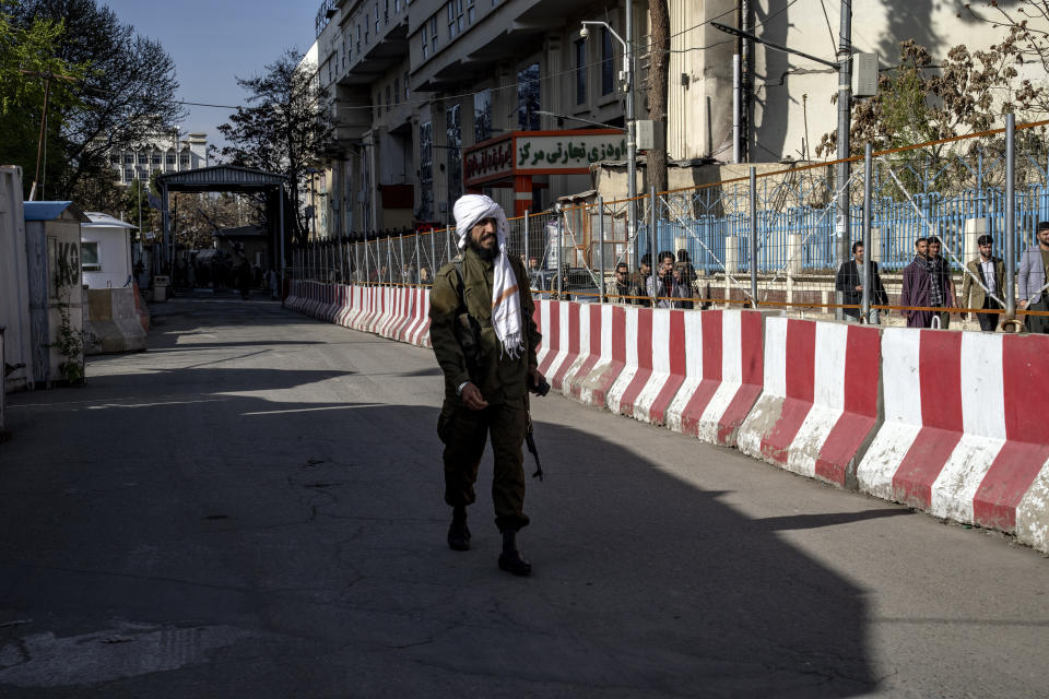 A Taliban fighter stands guard at the explosion site, near the Foreign Ministry in Kabul, Afghanistan, Monday, March 27, 2023. A suicide bomber has struck near the foreign ministry in the Afghan capital, killing at least six people and wounding about a dozen. (AP Photo/Ebrahim Noroozi)