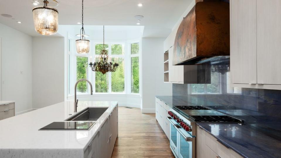 The gourmet chef’s kitchen was designed with Azul Macabus countertops. - Credit: Stephen Reed Photography