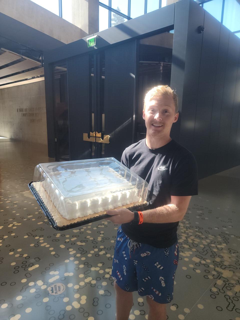 Mac Myers holding up Karly Blackburn's cake