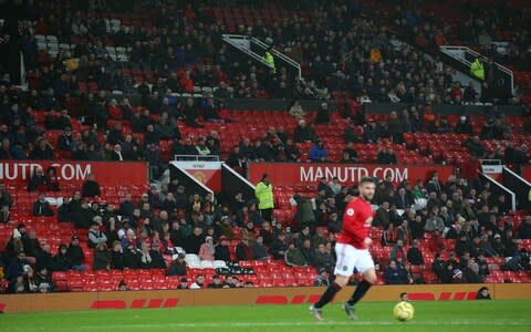 United fans started streaming out well before the end - Credit: GETTY IMAGES