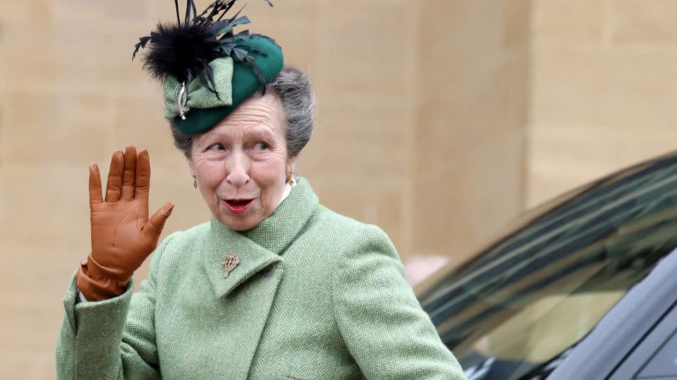 The Princess Royal waves to members of the public as she arrives for the family outing on Sunday. - Hollie Adams/Pool/AFP/Getty Images