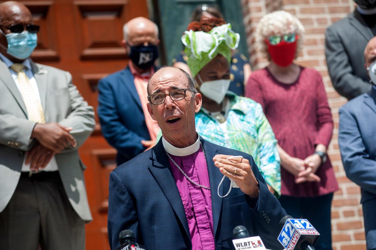 Brian Seage, bishop of the Episcopal Church of Mississippi, reads a statement from Working Together Mississippi, a diverse coalition of faith and civic institutions, outside St. Peter's Cathedral in Jackson, Mississippi, on June 11, 2020, calling to change the state flag. Seage will be leaving the diocese once a new bishop is named in February.