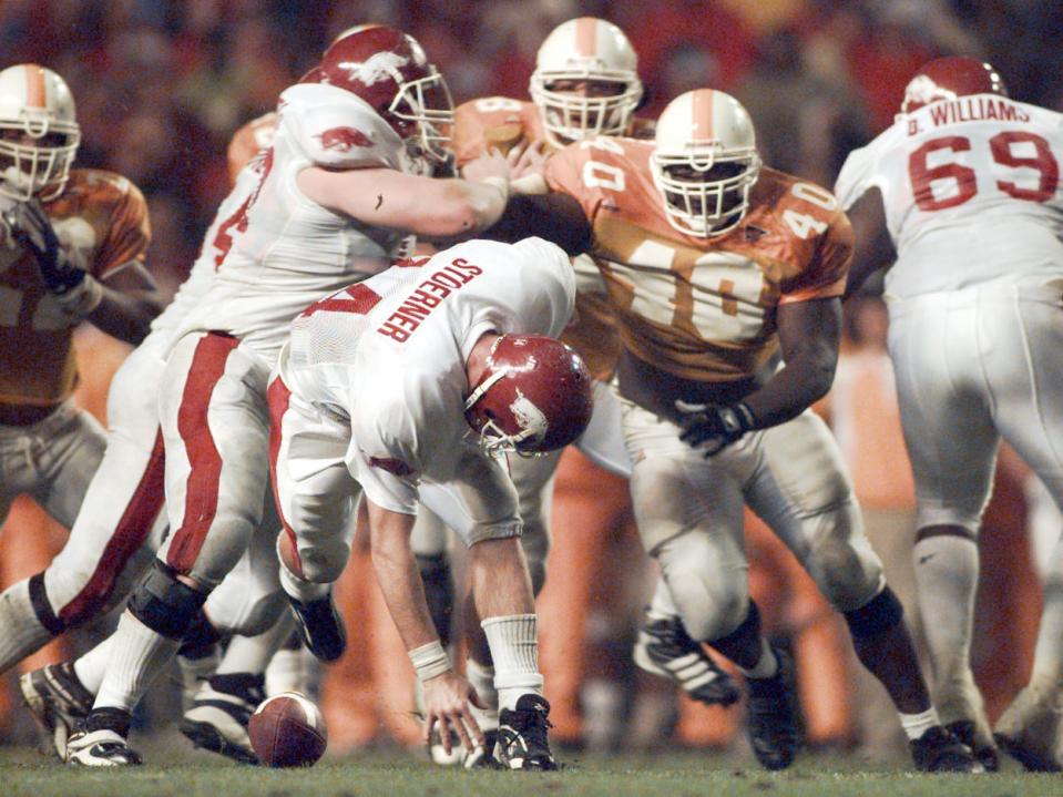 Arkansas' Clint Stoerner fumbles the ball in the closing minutes of play against Tennessee, turning the ball over Nov. 14, 1998. The Vols' Billy Ratliff recovered and Tennessee won the game 28-24. The play preserved Tennessee's undefeated season, and they went on to win the national championship.