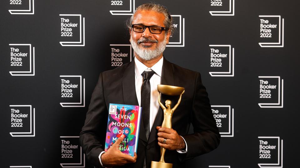 Author Shehan Karunatilaka holding trophy