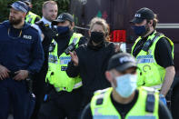 One protester is lead away by police outside the Newsprinters printing works at Broxbourne, Hertfordshire, other protesters use bamboo lock-ons and a van to continue to block the road. (Photo by Yui Mok/PA Images via Getty Images)