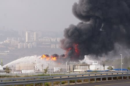 A blaze can be seen after fire erupted in a fuel tank at Oil Refineries Ltd in the Israeli northern city of Haifa December 25, 2016. REUTERS/Jinipix