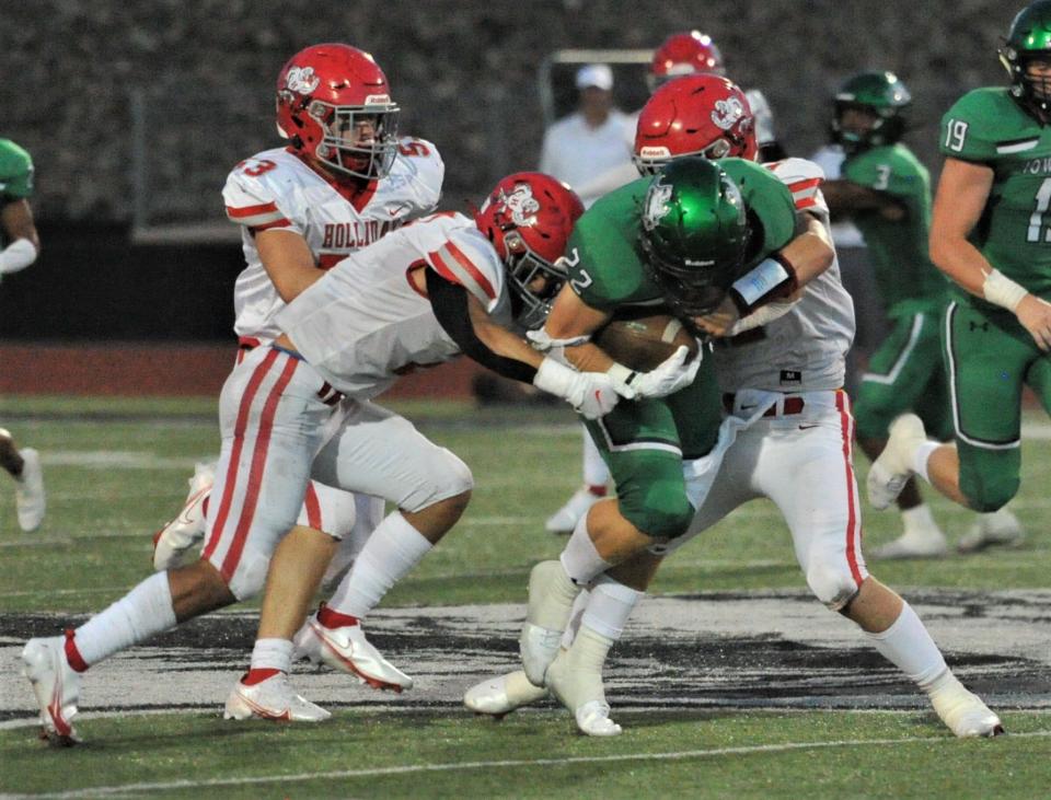 Iowa Park's C.J. Miser is tackled by the Holliday defense as Holliday leads 14-6 at halftime in Iowa Park.