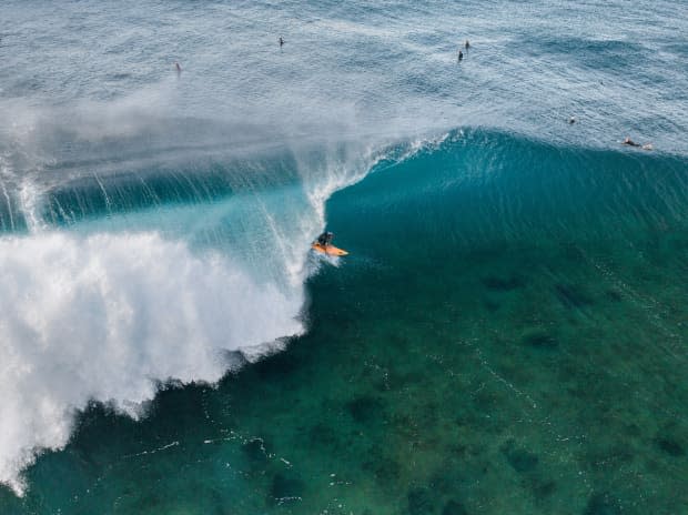 From a drone’s point of view, you begin to see how shallow the reef is out at Pipe as well as all the holes that add to the often shifty and slabby nature of the wave. Here, Shion Crawford picks his line accordingly.<p>Ryan "Chachi" Craig</p>
