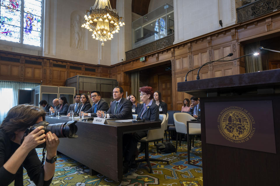 Mexico's agent and ambassador Carmen Moreno Toscano, center, and legal advisor Alejandro Celorio Alcantar, center left, wait for judges to enter the International Court of Justice in The Hague, Netherlands, Tuesday, April 30, 2024, where Mexico is taking Ecuador to the United Nations' top court accusing the nation of violating international law by storming into the Mexican embassy in Quito and arresting former Ecuador Vice President Jorge Glas, who had been holed up there seeking asylum in Mexico. (AP Photo/Peter Dejong)