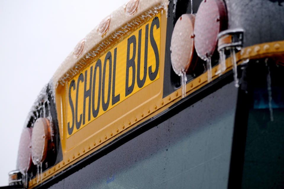 Icicles from sleet and rain coat a Richardson Independant School Bus that sits parked, Thursday, Feb. 2, 2023, in Richardson, Texas. Several school districts in the region have been closed the past three days because of the winter storm. (AP Photo/Tony Gutierrez)