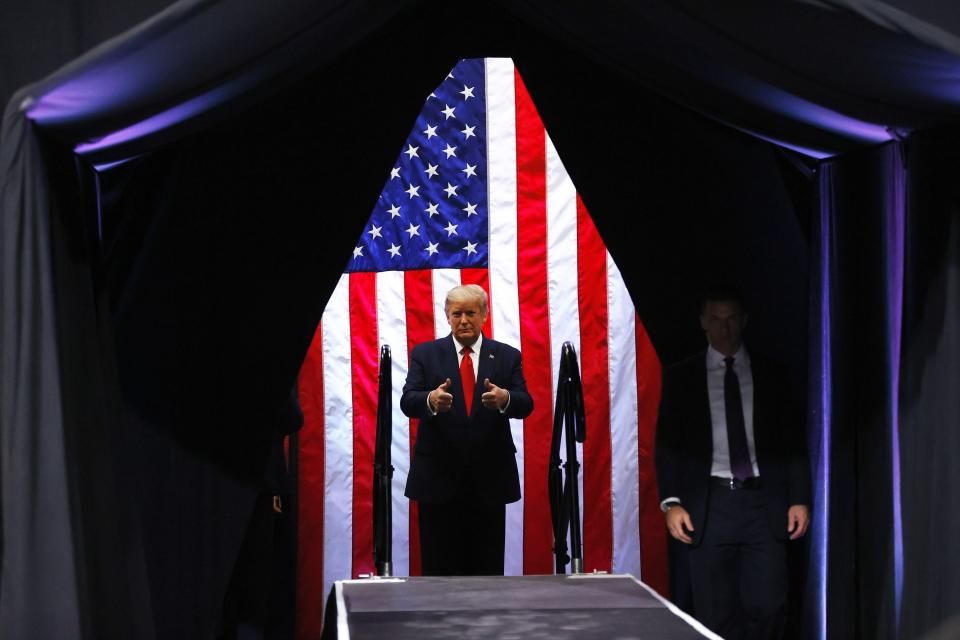 February 2020: President Donald Trump raises his thumbs up before going onstage to a rally at Veterans Memorial Coliseum in Phoenix.