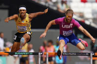 Joshua Abuaku, of Germany and CJ Allen, of the United States compete in a men's 400-meters hurdles heat during the World Athletics Championships in Budapest, Hungary, Sunday, Aug. 20, 2023. (AP Photo/Petr David Josek)