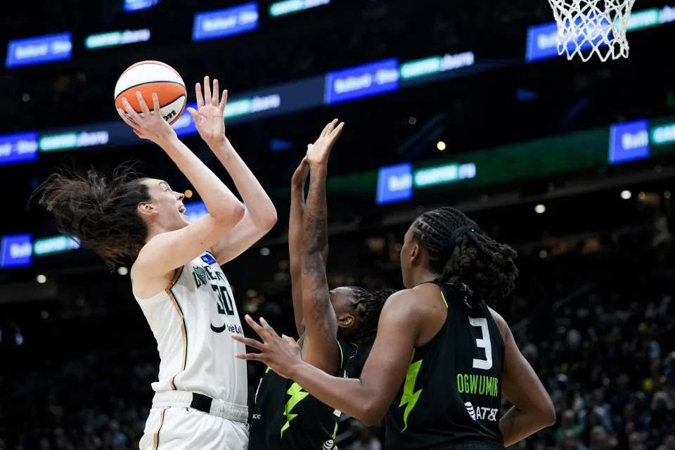 New York Liberty forward Breanna Stewart goes up to the basket against Seattle Storm guard Jewell Loyd, center, and forward Nneka Ogwumike (3) during the second half of a WNBA basketball game Friday, Aug. 30, 2024, in Seattle. The Liberty won 98-85. (AP Photo/Lindsey Wasson)