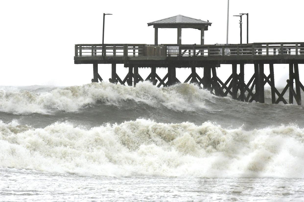 Heavy waves come ashore near the Oak Island Beach Pier Friday Sept. 30, 2022 in Oak Island, N.C. as the effects of Hurricane Ian move into Southeastern North Carolina.