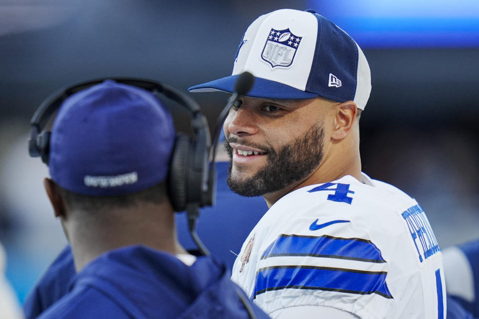 Dallas Cowboys quarterback Dak Prescott smiles on the sideline during the second half of an NFL football game against the Carolina Panthers Sunday, Nov. 19, 2023, in Charlotte, N.C. (AP Photo/Rusty Jones)