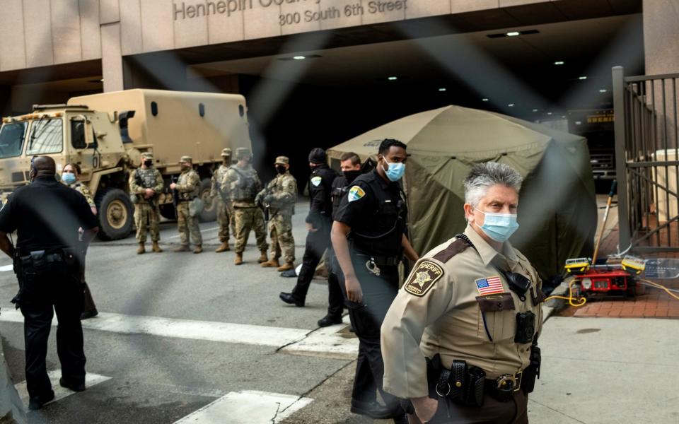 The National Guard stand watch outside the courthouse in Minneapolis - Stephen Maturen/Getty 