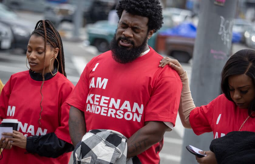 SANTA MONICA, CA - FEBRUARY 18: JaQuel Knight, center, leads a prayer before protesters march to a protest/disruption at Frieze Los Angeles on Saturday, Feb. 18, 2023 in Santa Monica, CA. (Brian van der Brug / Los Angeles Times)
