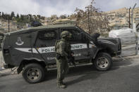 An Israeli policeman secures a shooting attack site in east Jerusalem, Saturday, Jan. 28, 2023. A Palestinian gunman opened fire in east Jerusalem on Saturday, wounding at least two people less than a day after another attacker killed seven outside a synagogue there in the deadliest attack in the city since 2008. (AP Photo/Mahmoud Illean)