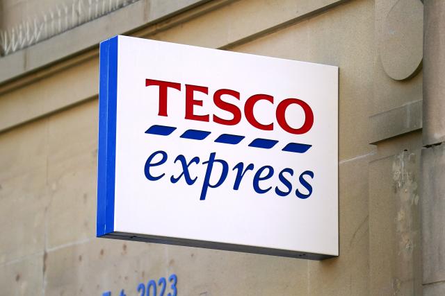 FTSE 100: Tesco profit halves to £1bn amid higher costs