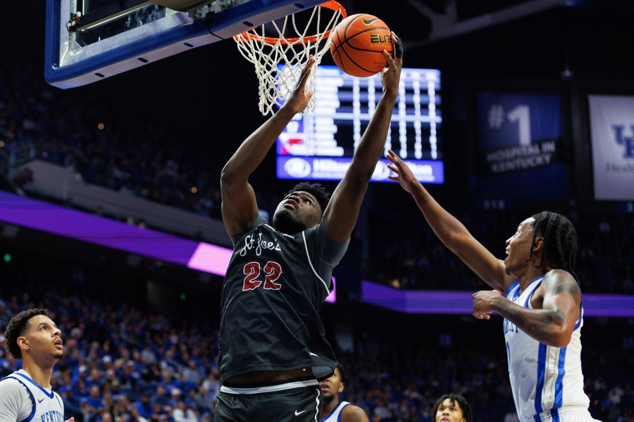 Saint Joseph's center Christ Essandoko (22) drives to the basket during the first half against the Kentucky Wildcats last fall. Essandoko has committed to the Providence Friars on Wednesday.