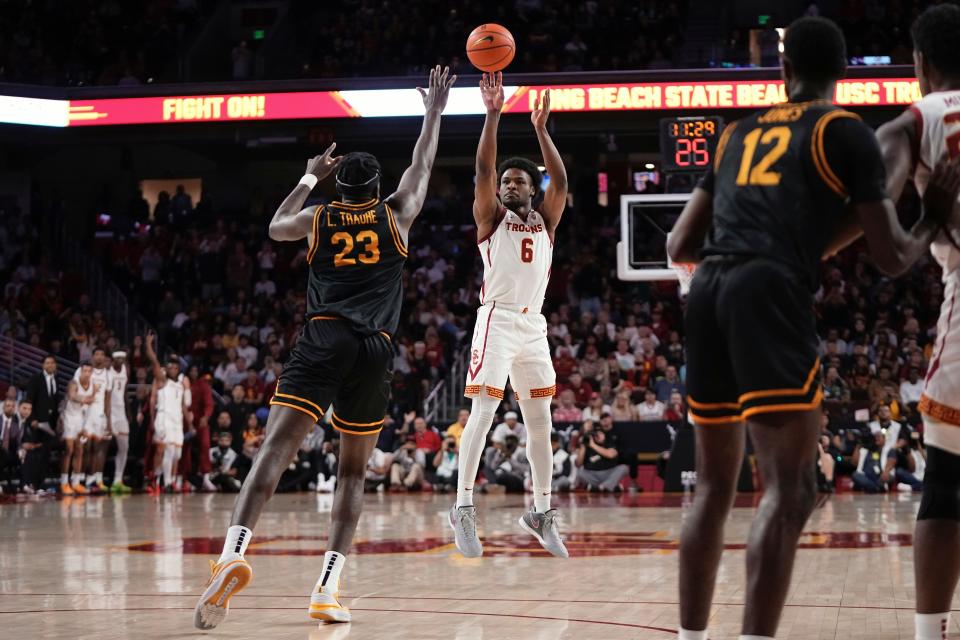 Southern California guard Bronny James (6) shoots as Long Beach State forward Lassina Traore (23) defends during the first half of an NCAA college basketball game Sunday, Dec. 10, 2023, in Los Angeles. (AP Photo/Mark J. Terrill)