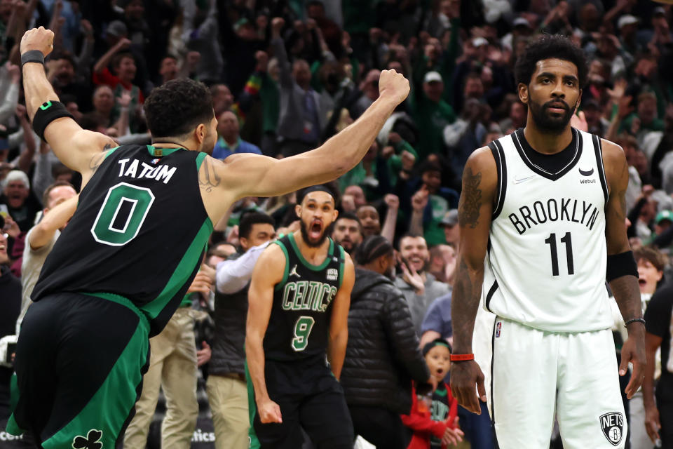 Celtics star Jayson Tatum celebrates his game-winning buzzer beater, as Nets counterpart Kyrie Irving leaves in defeat.  (Maddie Meyer/Getty Images)